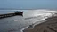 Placeholder: Detail of a pier or muddy beach, with subtle reflections and the boat as the main focal point.