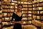 Placeholder: full-height shot of a woman in a tight black dress, inside a large magic book shop, shelving, lights, books, bottles, windows