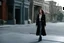 Placeholder: (photo from a movie by Quentin Tarantino) a woman detective investigates a strange case on ghosts killing people because a road perturbated their old HQ... She is standing on the sidewalk