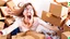 Placeholder: woman starts frantically tearing apart all the boxes and packaging