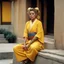 Placeholder: [very impressive high res masterpiece in Kodak Eastman 5247, bokeh scene by Stanley Kubrick] Elizabeth Montgomery, the Shaolin gangsta monk covered by tattoos, waiting outside in a yellow kimono on a stone doorstep. Her presence is striking, the tattoos on her knuckles adding to her intimidating aura. With a fierce glare, she menaces the camera with her two fists, each knuckle etched with intricate designs symbolizing her journey and battles fought.