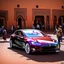 Placeholder: A Tesla's 'Model S Plaid' is parked, within 'Jemaa el-Fnaa', in Marrakesh. CINEMATIC. WIDE ANGLE LENS.