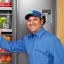 Placeholder: Refrigerator technician is smiling and working on the big refrigerator