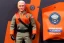 Placeholder: Mike pence G.i. Joe toy Space force uniform With accessories inside a blister packaging hanging on a Wallrack in toystore, fluorescent orange, toy guns, wide angle shot whole body, black moonboots, fullsize