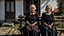 Placeholder: gloomy-looking old women sitting in black hungarian old villager dress and european black head scharf on wooden bench in front of white old house outside in an authentic east european ,hungarian village, high detalied, professional photo, high qualit, high textures. The high-resolution image captures the essence of authenticity and realism, transporting the viewer to another time and place.