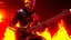 Placeholder: 4K. REALISTIC FULL DETAILS. UN TERMINATOR DEBOUT AVEC UNE GUITARE EN MAINS FIRESTARTER; flammes en fond