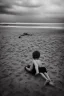 Placeholder: young boy on beach with a man laying down behind him, dark storm clouds overhead, gloomy, bleak, shopping trolley on side, dusk. the road cormac mccarthy