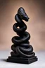 Placeholder: an ominous small statuette made of ebony in the form of a mountain with the snake slithering around the mountain