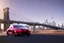 Placeholder: A Tesla 'Model 3' is going at a high speed, on the 'FDR Drive', eastern Manhattan. (CINEMATIC, WIDE ANGLE LENS, PHOTO REAL)