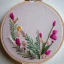 Placeholder: embroidery hoop with delicate embroidery and beadwork of flowers, tulle, couture, beautiful composition, aesthetic layout, wildflowers, watercolor