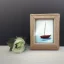 Placeholder: tiny oil painting of tiny sailboat, tiny white canvas, tiny white frame, melancholy, tender, moody, vintage, delicate arrangement, beautiful composition, etsy, aesthetic layout, plain solid white background