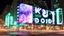 Placeholder: a billboard branded writing ODK Tokusentai , with neon light green and white , in the city center, at night . At Montréal