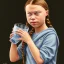 Placeholder: portrait Greta Thunberg drinking milk from a cat