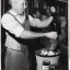 Placeholder: William Luby pouring a bucket full of beer on his own head at a pub