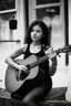 Placeholder: beautiful woman playing acoustic guitar in mid west blck and white old photto