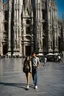 Placeholder: A realistic photo of a Milano in Duomo in the background, a pair of inamorato young people on the street, typically Italian, late evening, last shine of sun. Photo taken by Mamiya M645 camera with low-speed film, highly detailed, wide lens.