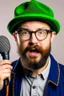 Placeholder: Man fires up with a microphone in his hand, wears glasses, hat, small beard, looks like a clog.