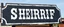 Placeholder: fill composition with large and wide hand painted old western sign that reads: "SHERRIF" white on black with inset white stripe aged paint
