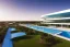 Placeholder: Sunset algarve in quinta do lago, one straight line building of 250 meters long modern luxury architecture with pool on rooftop, with green roofs and sun loungers next to pool, overlooking a tennis and padel sport facility and inserted in the Ria Formosa Natural park, on a slope with pinus pinea, a wrap around low speed veicular road