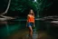 Placeholder: beautiful girl in blue short and orange top walking in water toward camera in trees next to wavy river with clear water and nice sands in floor.camera capture from her full body front