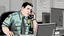 Placeholder: male cop dispatcher deals with virus on the phone