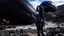 Placeholder: A woman in a catsuit standing on a beach of a rocky landscape with a crashed spaceship in the distance