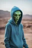 Placeholder: humanlike green alien wearing blue hoodie and gray beanie on planet