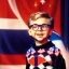 Placeholder: ralphie peter billingsley glasses, cheeky boy in argyle sweater holding a bar of (red soap)