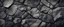 Placeholder: Black rock texture. Rough mountain surface with cracks. Close-up. Stone background with space for design.