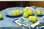 Placeholder: Lemons on a table with a blue napkin, impressionnist oil on canvas by Paul Cézanne, 1887, broad brushstrokes, canvas relief