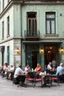 Placeholder: People sitting on tables having diner in front An old abandoned building with green walls
