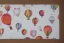 Placeholder: giftwrap pattern of watercolor of a hot air balloon, children's book illustration, white parchment paper, giftwrap pattern