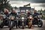 Placeholder: a very hard and tuff motorcycle young gang with Keltic hair , not old, posing with their Harley Davidsson bikes, some of them holding guns and shotguns, a logo sign with "FALKÖPING HD", "FEARLESS SINNERS" Skulls and bones, skeletons and fire, Swedish town Falköping in background, Swedish flags on bikes, Simon Stålenhag style