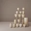 Placeholder: studio photography of a set of highly detailed irregular non-existent glass products, stacked in impossible balance, perfect composition, film studio light, beige color scheme, indirect lighting, 8k, elegant and luxurious style