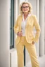 Placeholder: Powerful classical portrait of a modern blonde politician with glasses in her mid 40s wearing a pastel yellow pant suit standing in a elegant position