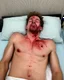 Placeholder: A snapshot, capturing a gaunt, shirtless Caucasian male corpse lying on a cheap motel bed. His face is swollen and discolored, a hole in his right cheek distorting his features, leaving dark red goo matted in his shaggy brown hair. Stubble shadows his jaw, his half-open mouth slack, eyes partially closed. The pillow beneath his head is soaked in a large dark red, congealed pool of goo, speckled with flecks of spatter, while his bare torso remains eerily clean, pale