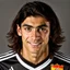 Placeholder: 85mm DSLR color photography of a very detailed headshot fitting all of head and hair in frame. 19-year-old Spanish soccer player, and with no facial hair and has no facial hair, has medium length straight black hair with a small smile, grey background