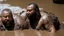 Placeholder: wide angle photography of two 55 years old marocan burly chubby mud men fighting in the mud, long hair, beards, manly chest, bullneck , photorealistic , view from the ground