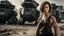 Placeholder: beautiful slender caucasian female technician with a knife, looking away from camera, black tank top, well toned muscles, weathered face, scratched sand camo metal details, short brunette wavy bob haircut, dystopian, postapocalyptic city scene with smoke and explosions. giant robot in the background