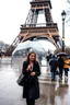 Placeholder: around Eiffel tower a few people with umbrella walking while it is raining and the Eiffel is seen complete,a pertty lady with nice umbrella is comming to camera