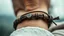 Placeholder: very close-up macro photo of a bracelet made of brown leather and onix on a woman's wrist, detailed, sharp contrasts, realistic, cinematic, blur background