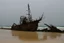 Placeholder: A shipwreck on a beach that has a camp on it