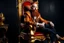 Placeholder: man with red beard sitting in a gothic armchair, golden armrests with trim