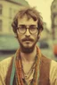 Placeholder: Hippie bohemian young man with Parisian bohemian look and glasses of colours and poor and short short short and poor hair on the head with receding hairline. Farsightedness glasses with big eyes. Long beard. Vintage look and feel like photo styleof the 70s