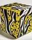 Placeholder: A brown cube-shaped rock painted by Roy Lichtenstein