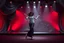 Placeholder: modern stage with gray-dark red theme artistic decoration , color full dynamic lighting, a beautiful lady in pants and blouse with shining silver jewels dancing, 3D recursive fractal structure animating background