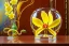 Placeholder: hypersigil photograph of a beautiful yellow and red orchid in a clear glass rococo inspired vase on a mirrored deco themed end table in a shadowy corner of a nouveau era room with wood paneling in the style of Robert maplethorpe, tropical birds, lizards, snakes, insects, gorgeous, shamanic, ethereal, photorealistic, embellishments, long shot, wide shot, dof, deep focus, 3d render