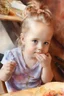 Placeholder: watercolor painting of a beautiful portrait of a 5 year old girl realistic skin texture, flower in her hair, looking into the camera, Anna Razumovskaya style, atmospheric light, realistic colors