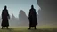 Placeholder: Black robed, hooded monks in the field