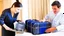 Placeholder: hotel employee rummaging through customer's suitcase